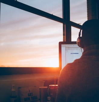 man sitting facing monitor