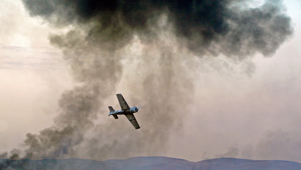 panning photography of flying blue and white biplane