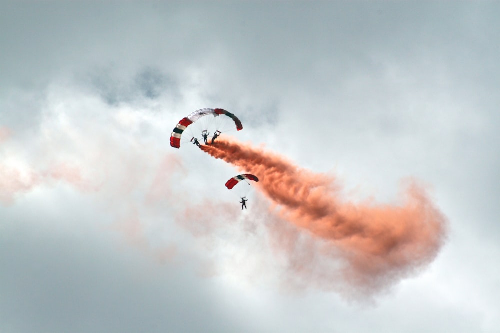 worms eye view photography of people paragliding under cloudy sky