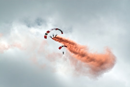 worms eye view photography of people paragliding under cloudy sky in Farnborough Airport United Kingdom