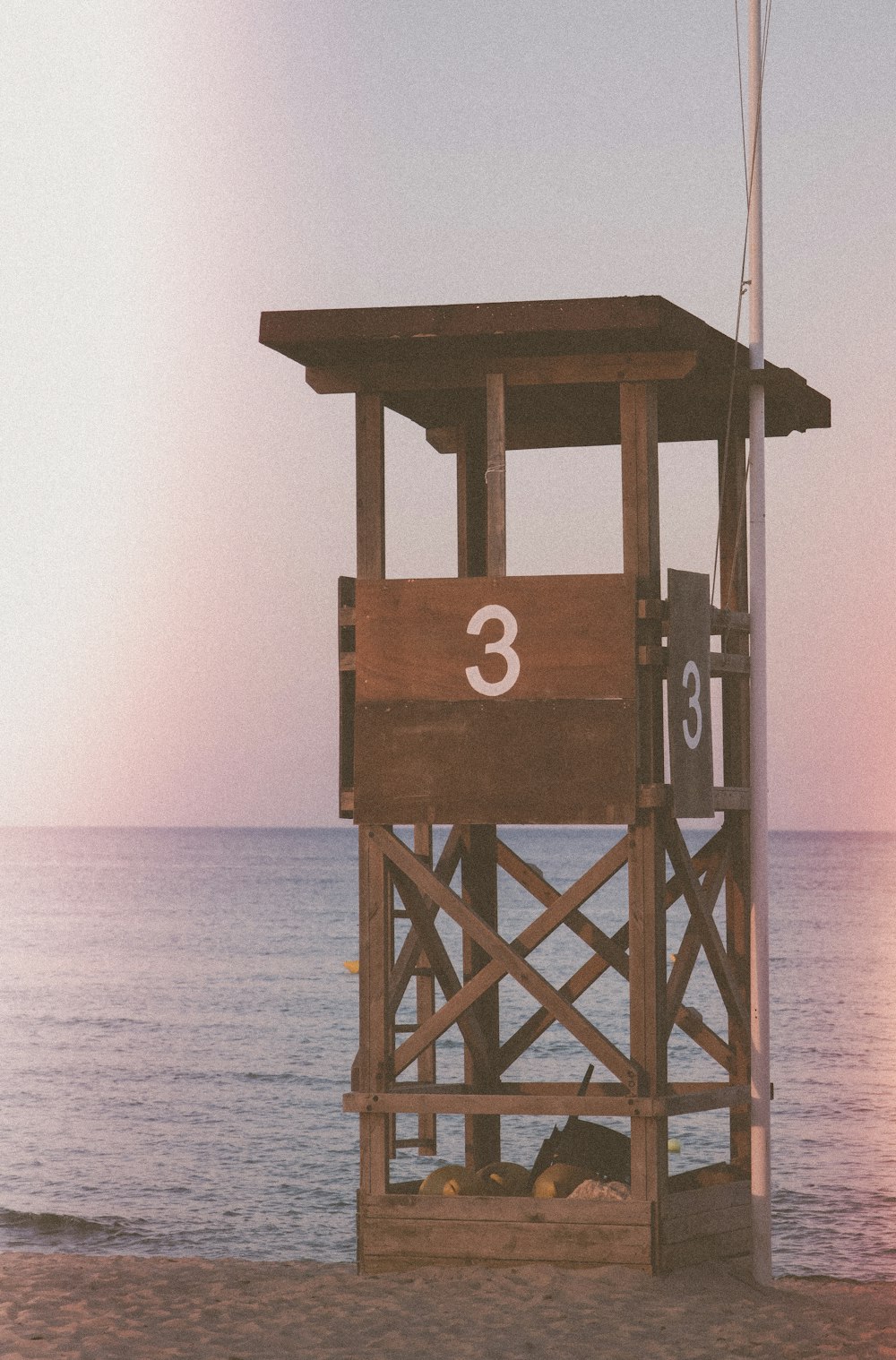 a lifeguard tower on the beach with the number 3 on it