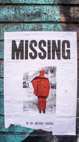 A close-up of a missing child's photo pinned on a community bulletin board surrounded by supportive notes.