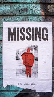 A close-up of a missing child's photo pinned on a community bulletin board surrounded by supportive notes.