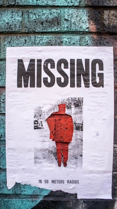 Close-up of a missing child poster pinned on a community bulletin board with hopeful messages around it.