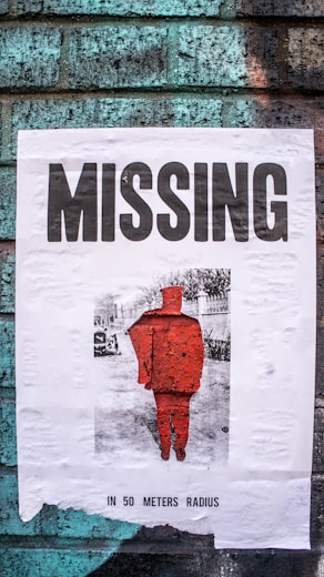 Close-up of a missing child poster pinned to a community bulletin board.