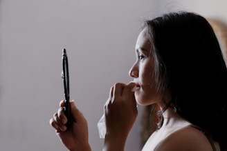 woman looking to mirror and wiping her lips