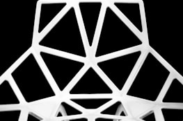 Abstract architectural lines forming a harmonious pattern in matte black against a white background.