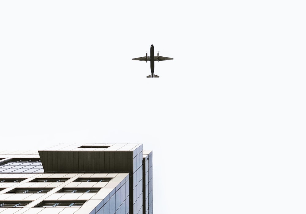 airplane flying over the building