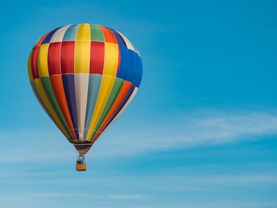 panning photography of flying blue, yellow, and red hot air balloon hot air balloon google meet background