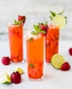three clear drinking glasses filled with juice