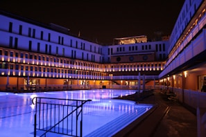 Modern residential pool with sleek LED underwater lights glowing at dusk