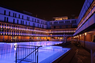 Modern residential pool with sleek LED underwater lights glowing at dusk