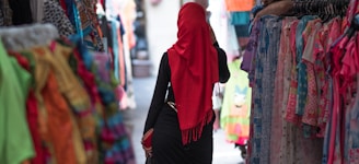 A model wearing a sisyph lab cap walking through a vibrant Moroccan street market.