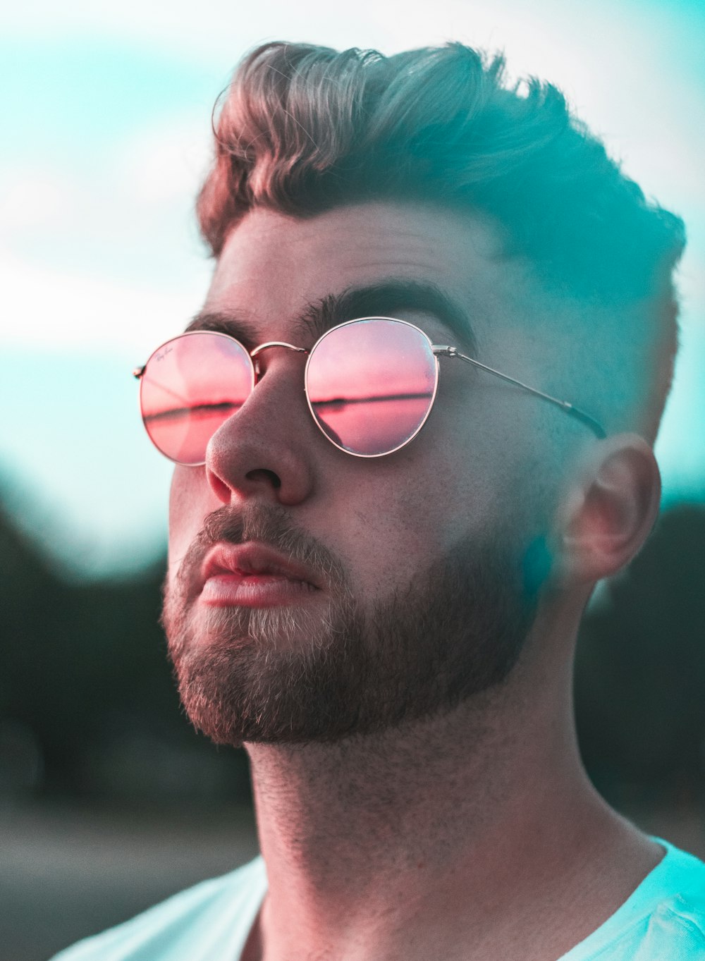 close-up photography of man wearing red lens sunglasses