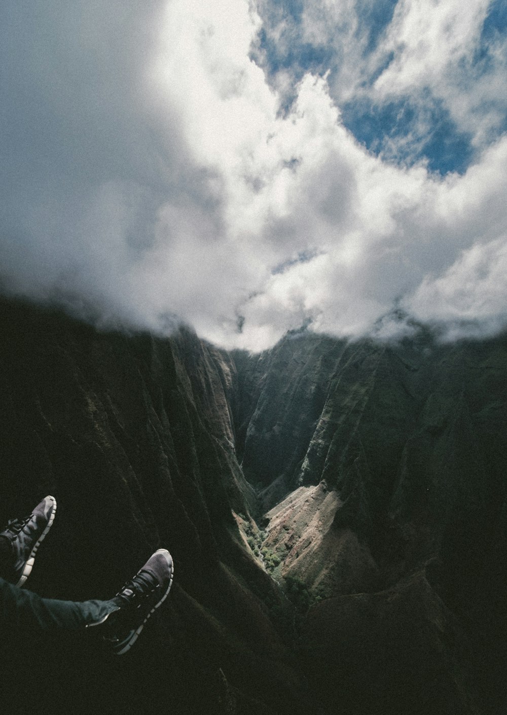 mountains under cloudy blue sky during daytime