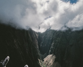 mountains under cloudy blue sky during daytime