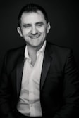 A smiling candidate in a professional interview setting.