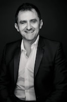 Jo Tan hosting an event with a warm smile, engaging the audience.