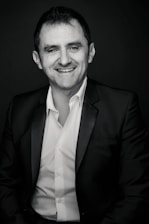 A professional advisor explaining insurance options to a client with warm smiles.