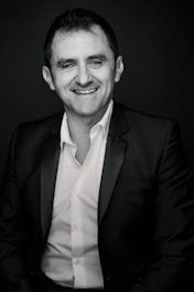 Portrait of Paolo Cusimano engaging warmly with clients in a professional setting