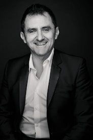 A candid photo of a professional receiving an award on stage with a warm smile.