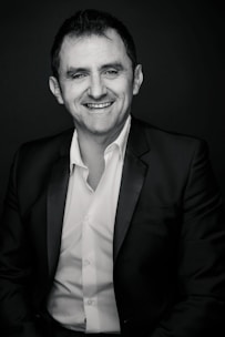 A professional advisor explaining insurance options to a client with warm smiles.