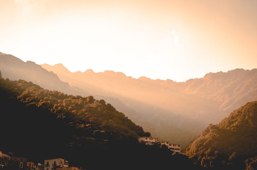 white building in the middle of mountain during sunset