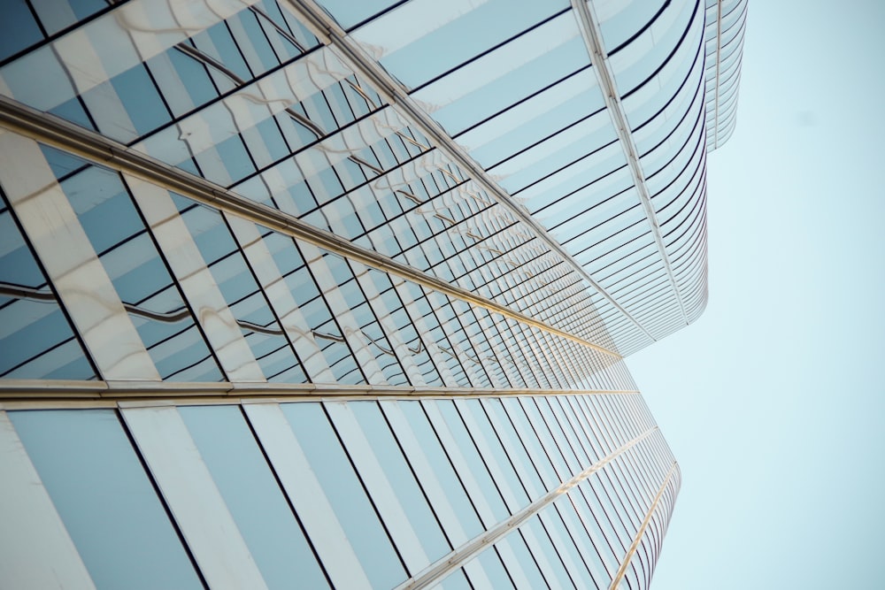 a tall glass building with a sky background