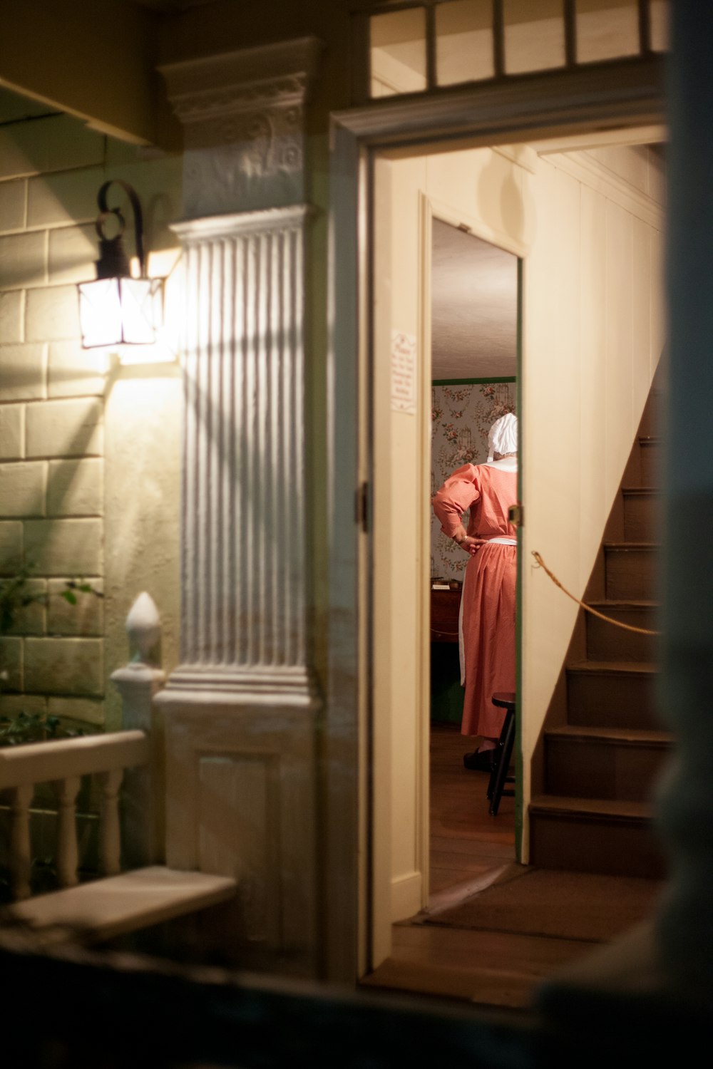 woman in red robe standing on hallway