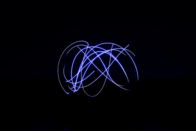A sleek abstract digital horizon with glowing cyan and gold light trails converging into a futuristic circular lens.