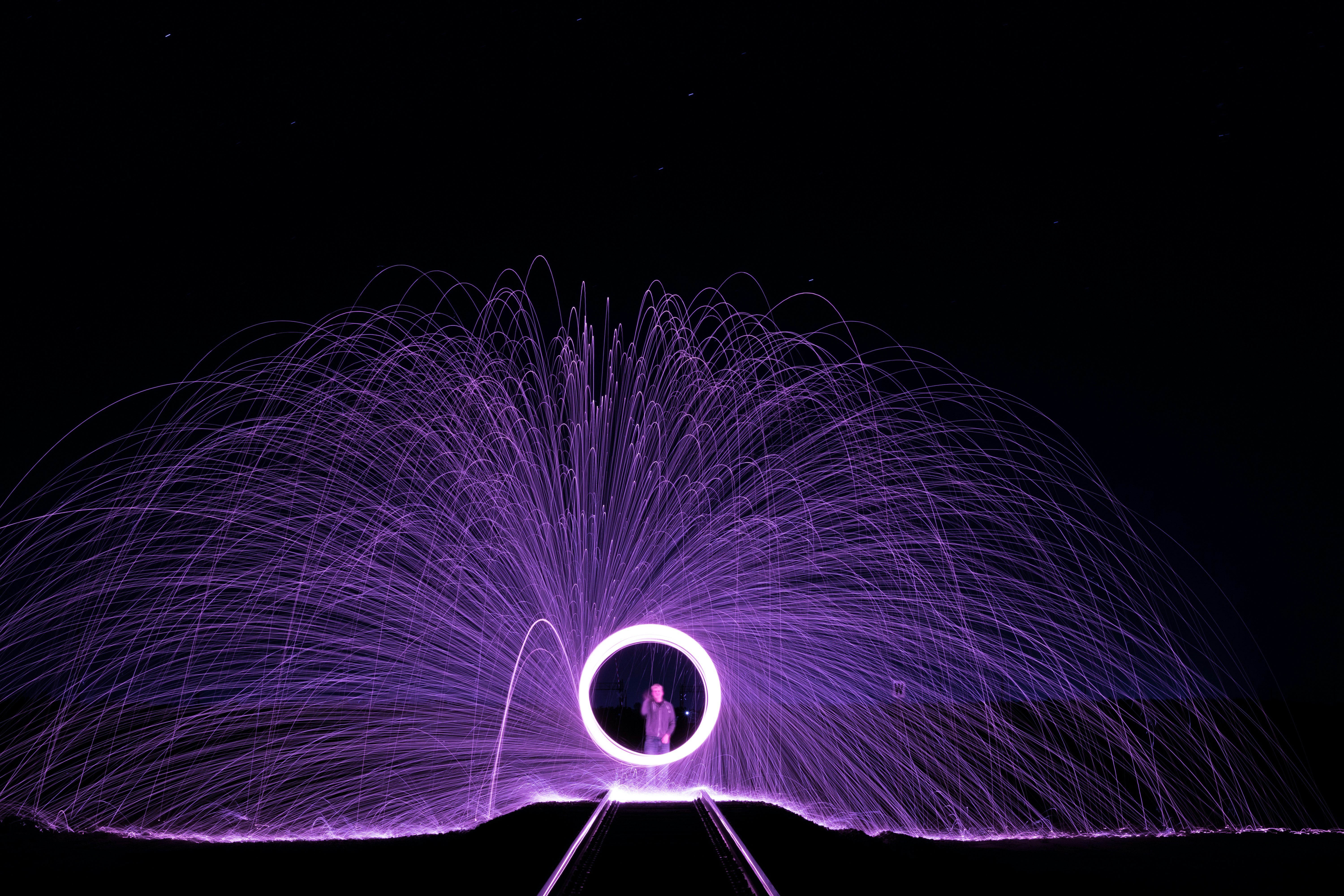 man standing in front of steel wool photography