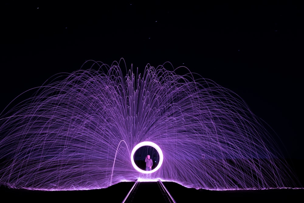 man standing in front of steel wool photography