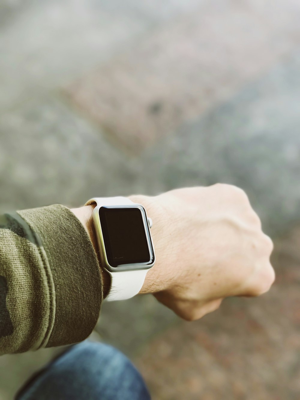 person wearing silver platinum Apple Watch and white Sport Band