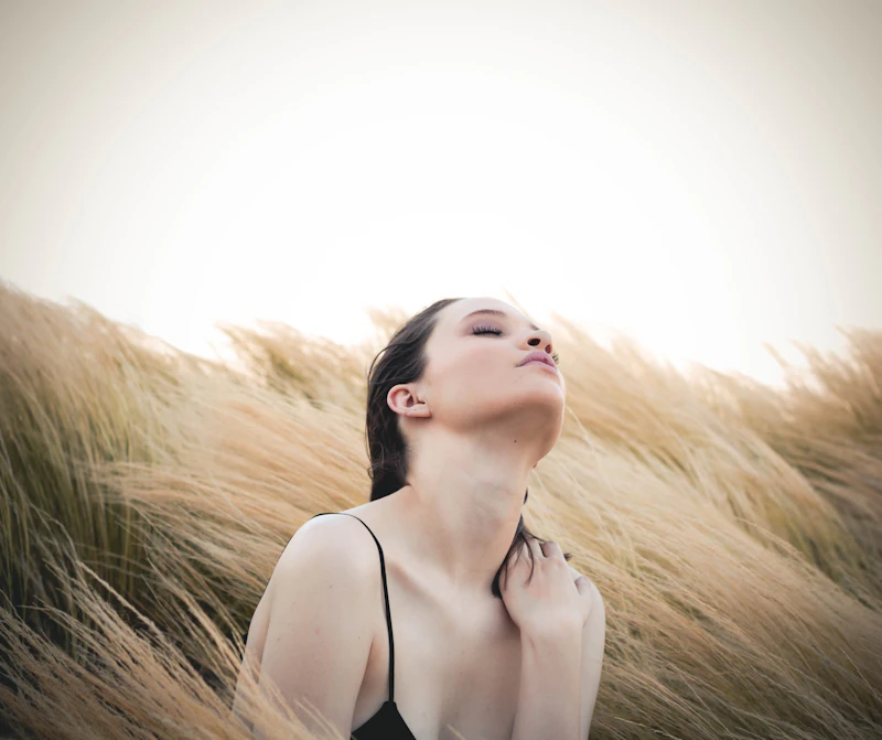 Woman breathing outdoors in a calm, natural setting