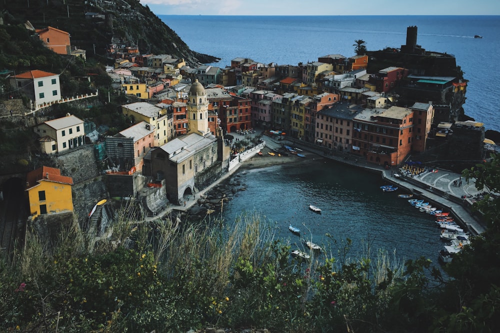 aerial photography of multicolored houses beside body of water