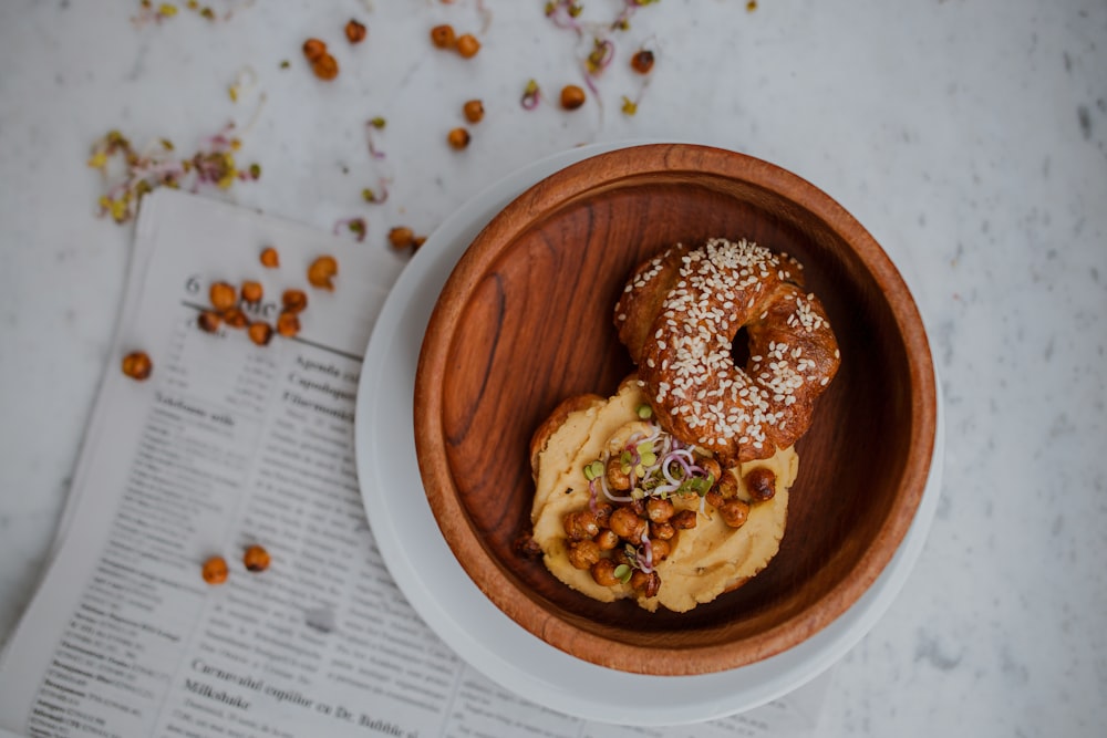 doughnut in round brown wooden tray