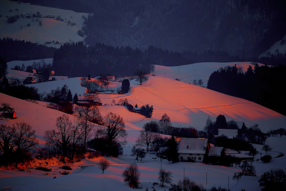 snow covered town during sunset