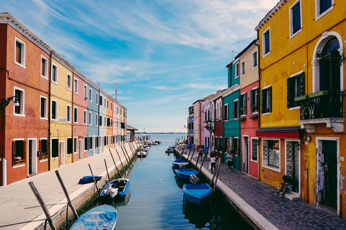 Venice autumn with reflected orange buildings in canal water