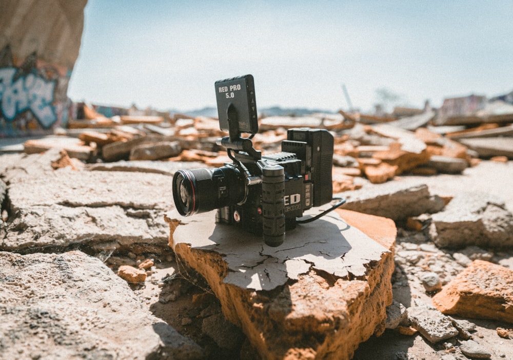 black camera on gray and brown stone