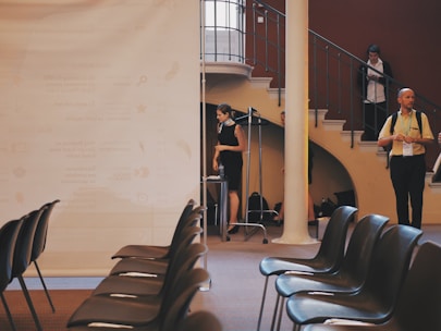 A professional seminar setup with chairs and a projector.