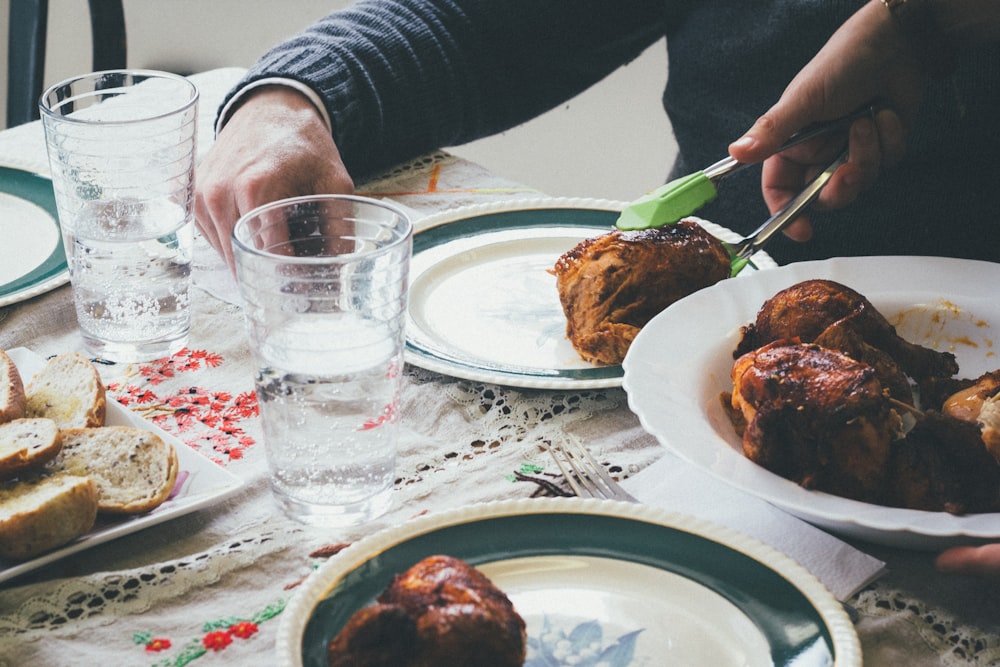 person holding cooked food with tongs