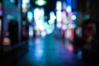 A nighttime cityscape blurred with neon lights, reflecting the music's atmosphere.