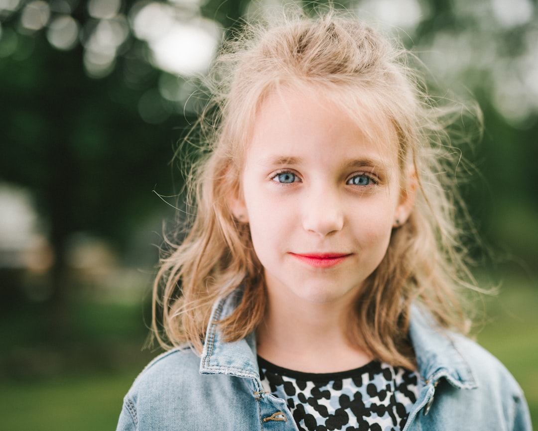 smiling girl in blue denim jacket,
