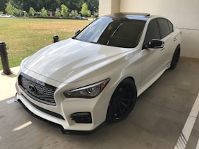 Close-up of a sleek sedan with freshly tinted windows under bright sunlight.