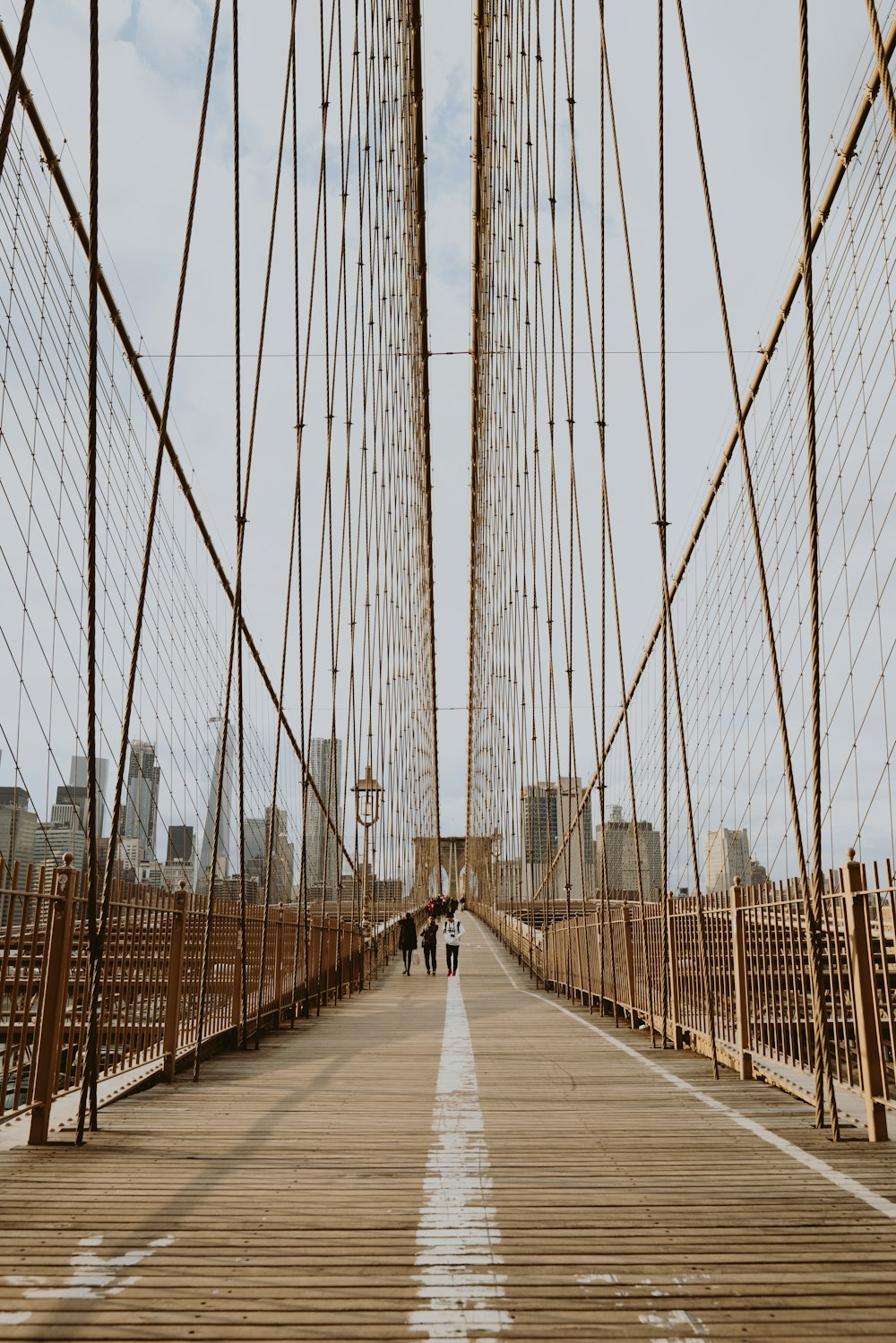 people walking on Brooklyn Bridge