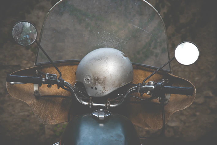 Close-up of a rugged motorcycle helmet resting on a vintage leather seat