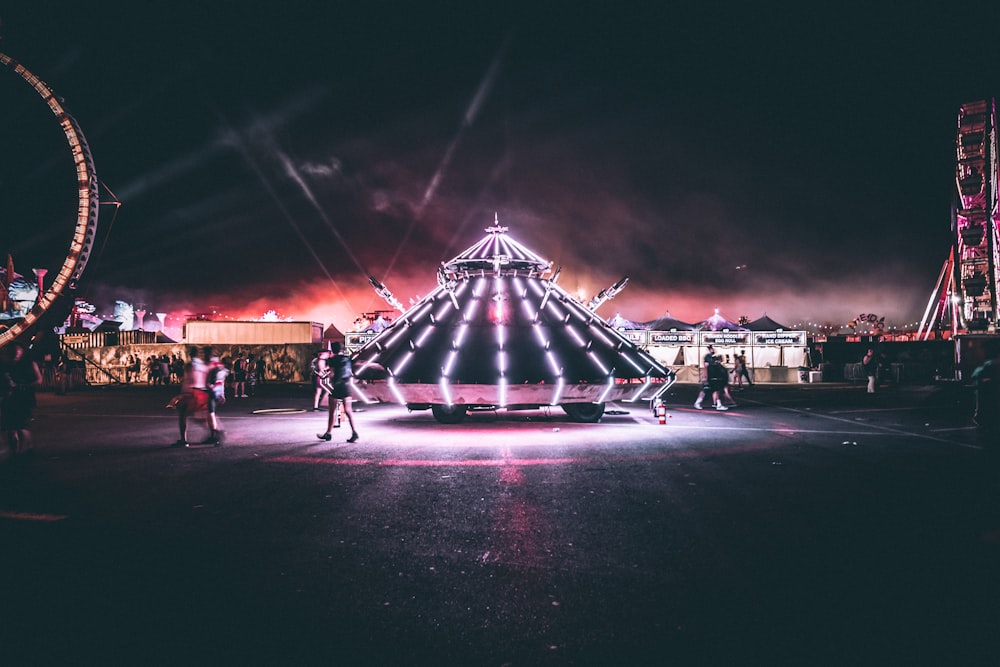 person standing near triangular carnival ride