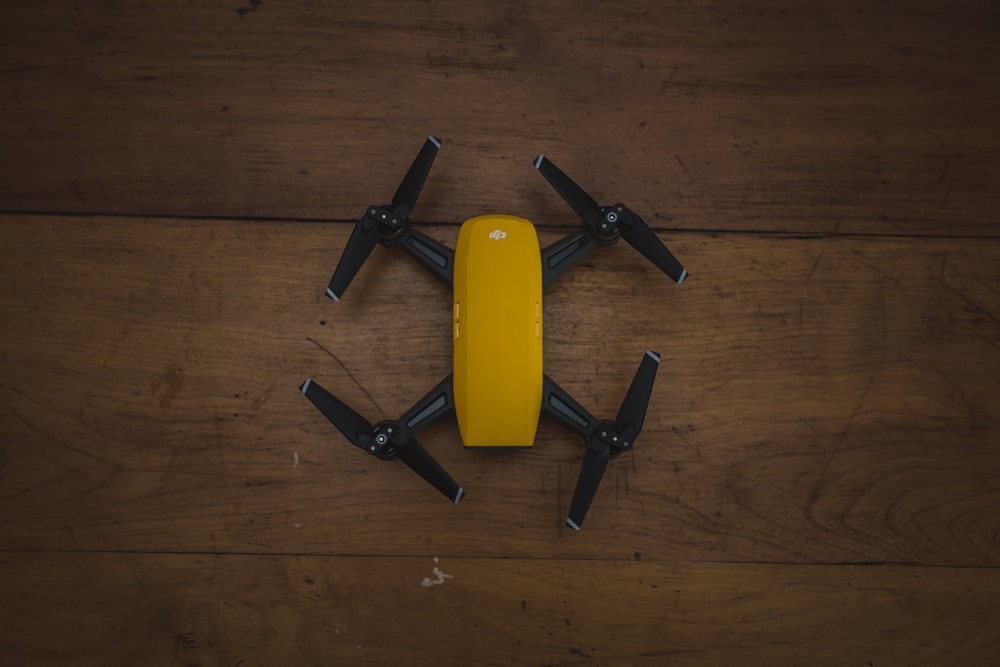 yellow and black drone on wooden surface