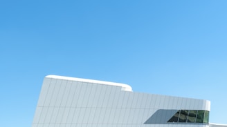 A sleek modern portacabin set against a clear blue sky in Jeddah.