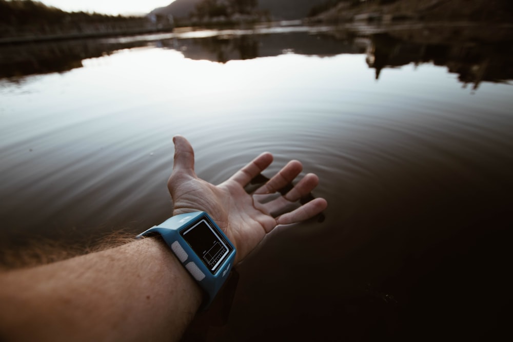 person touching body of water